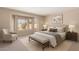 Cozy bedroom featuring a bay window, neutral color palette, and plush carpeting at 3631 E Long Lake Rd, Phoenix, AZ 85048