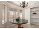 Bright dining area with views of the backyard through large windows, with stylish lighting and lots of storage at 3631 E Long Lake Rd, Phoenix, AZ 85048