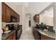 Efficient kitchen featuring granite countertops, wood cabinetry, and essential appliances in a functional layout at 3631 E Long Lake Rd, Phoenix, AZ 85048