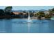 Scenic lake view featuring a water fountain and homes with red tile roofs, against a backdrop of distant mountains at 3631 E Long Lake Rd, Phoenix, AZ 85048