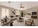 Bright living room with vaulted ceiling, ceiling fan, and sliding glass door leading to the backyard at 3631 E Long Lake Rd, Phoenix, AZ 85048