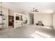 Open-concept living area, featuring neutral carpet and paint, with views into the kitchen and dining areas at 3631 E Long Lake Rd, Phoenix, AZ 85048