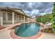 Sparkling swimming pool with rock feature surrounded by lush greenery and a covered patio at 3631 E Long Lake Rd, Phoenix, AZ 85048