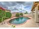 Sparkling pool with rock waterfall feature, surrounded by lush, mature landscaping and privacy bushes at 3631 E Long Lake Rd, Phoenix, AZ 85048