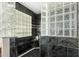 Chic shower with sleek black tile, glass block accents, and a built-in shelf at 3631 E Long Lake Rd, Phoenix, AZ 85048