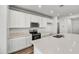 Well-equipped kitchen with stainless steel appliances, white cabinets, and ample counter space for cooking and entertaining at 37535 W Patterson St, Maricopa, AZ 85138