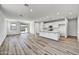 Spacious living area seamlessly connects to the kitchen with stylish flooring and ample natural light, perfect for modern living at 37535 W Patterson St, Maricopa, AZ 85138