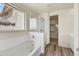 A bright bathroom features a glass-enclosed shower and separate soaking tub with wood-look floors at 37549 W San Clemente St, Maricopa, AZ 85138
