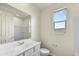 Clean bathroom featuring a white vanity, large mirror, and walk in shower with neutral paint at 37549 W San Clemente St, Maricopa, AZ 85138