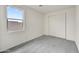 Carpeted bedroom featuring neutral paint, a window, and sliding closet doors at 37549 W San Clemente St, Maricopa, AZ 85138
