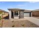 Charming single-story home featuring stone accents, a well-maintained yard and a two-car garage at 37549 W San Clemente St, Maricopa, AZ 85138