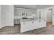 Well-equipped kitchen with quartz countertops, ample white cabinetry, and stainless steel appliances at 37549 W San Clemente St, Maricopa, AZ 85138