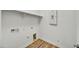 A bright laundry room with a shelf and utility hookups at 37549 W San Clemente St, Maricopa, AZ 85138