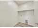 Bright laundry room features a shelf, washer hookups, dryer hookups and hard surface floors at 37549 W San Clemente St, Maricopa, AZ 85138