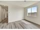 Bright, airy living room featuring modern laminate flooring and neutral wall paint at 37549 W San Clemente St, Maricopa, AZ 85138
