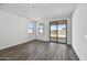 A sunny living area with wood-look floors and sliding glass doors leading to the outdoor space at 37549 W San Clemente St, Maricopa, AZ 85138