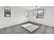 Bedroom with plush gray carpet, bright natural light, and views of the neighborhood at 37551 W Patterson St, Maricopa, AZ 85138