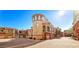 Exterior view of townhomes with balconies, garages, and red brick driveways under blue sky at 3935 E Rough Rider Rd # 1016, Phoenix, AZ 85050