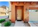 Exterior view of a home featuring a front door, a welcome mat, and a garage at 3935 E Rough Rider Rd # 1016, Phoenix, AZ 85050