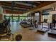 A spacious gym features state-of-the-art exercise equipment with floor-to-ceiling windows overlooking outdoor scenery at 3935 E Rough Rider Rd # 1016, Phoenix, AZ 85050