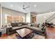 Inviting living room with plush sectional sofa, ceiling fan, and large windows at 3935 E Rough Rider Rd # 1016, Phoenix, AZ 85050