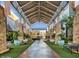 A beautifully landscaped walkway leads to shops with textured stone columns and benches along the way at 3935 E Rough Rider Rd # 1016, Phoenix, AZ 85050