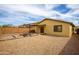 Expansive backyard featuring desert landscaping, a cozy firepit area, and a covered patio, perfect for outdoor enjoyment at 44944 W Miramar Rd, Maricopa, AZ 85139