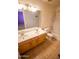 Bathroom features a double sink vanity, tiled flooring, and a shower-tub combo at 44944 W Miramar Rd, Maricopa, AZ 85139