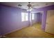 Bedroom featuring a ceiling fan, plush carpet, and a mirrored closet at 44944 W Miramar Rd, Maricopa, AZ 85139