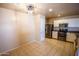 Modern kitchen with stainless steel appliances, white cabinets, tile flooring, and ample counter space, great for entertaining at 44944 W Miramar Rd, Maricopa, AZ 85139