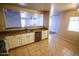 Spacious kitchen featuring stainless steel appliances, white cabinets, tile flooring, and an open layout, perfect for cooking at 44944 W Miramar Rd, Maricopa, AZ 85139