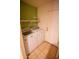 The laundry room includes a washer, dryer, and shelving at 44944 W Miramar Rd, Maricopa, AZ 85139