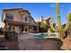 Backyard boasts refreshing pool, desert landscaping, and an outdoor kitchen at 4753 E Bighorn Ave, Phoenix, AZ 85044