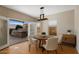 Bright dining area featuring a round wood table, four chairs, and an open doorway to an outdoor kitchen at 4753 E Bighorn Ave, Phoenix, AZ 85044