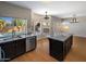 Well-lit kitchen boasts granite countertops, stainless steel appliances, and a center island at 4753 E Bighorn Ave, Phoenix, AZ 85044