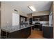 Modern kitchen featuring stainless steel appliances, granite countertops, and island at 4753 E Bighorn Ave, Phoenix, AZ 85044