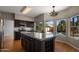 Well-appointed kitchen with granite countertops, dark cabinets, and a central island at 4753 E Bighorn Ave, Phoenix, AZ 85044