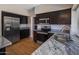 Updated kitchen with stainless steel appliances and elegant granite countertops at 4753 E Bighorn Ave, Phoenix, AZ 85044