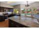 Kitchen with granite countertops, stainless steel appliances, and a view of the pool at 4753 E Bighorn Ave, Phoenix, AZ 85044
