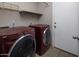 Laundry room features a washer, dryer, and built-in shelving for storage at 4753 E Bighorn Ave, Phoenix, AZ 85044