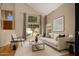 Vaulted living room with large windows, neutral decor, and stylish furnishings at 4753 E Bighorn Ave, Phoenix, AZ 85044