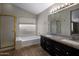 Well-lit main bathroom with dual sinks and soaking tub at 4753 E Bighorn Ave, Phoenix, AZ 85044