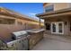 Built-in outdoor kitchen featuring a grill, countertop, and stone accents at 4753 E Bighorn Ave, Phoenix, AZ 85044
