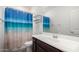 Bright bathroom features a white vanity with a modern sink and a shower with a beach-themed curtain at 4901 S Turbine --, Mesa, AZ 85212