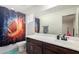 Bright bathroom features a dark brown vanity with a white sink and a shower with a football-themed curtain at 4901 S Turbine --, Mesa, AZ 85212