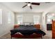 Bedroom featuring a ceiling fan, natural light, an ensuite and two side tables at 4901 S Turbine --, Mesa, AZ 85212