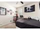 Cozy bedroom setup with a computer desk, decorative shelves, and black-out curtains at 4901 S Turbine --, Mesa, AZ 85212