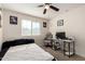 Bedroom features neutral walls, a window, a ceiling fan, and modern black and white decor at 4901 S Turbine --, Mesa, AZ 85212