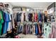 Walk-in closet fully stocked with clothing hanging on rods at 4901 S Turbine --, Mesa, AZ 85212