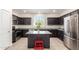 Modern kitchen with stainless steel appliances, dark cabinets, and a center island at 4901 S Turbine --, Mesa, AZ 85212